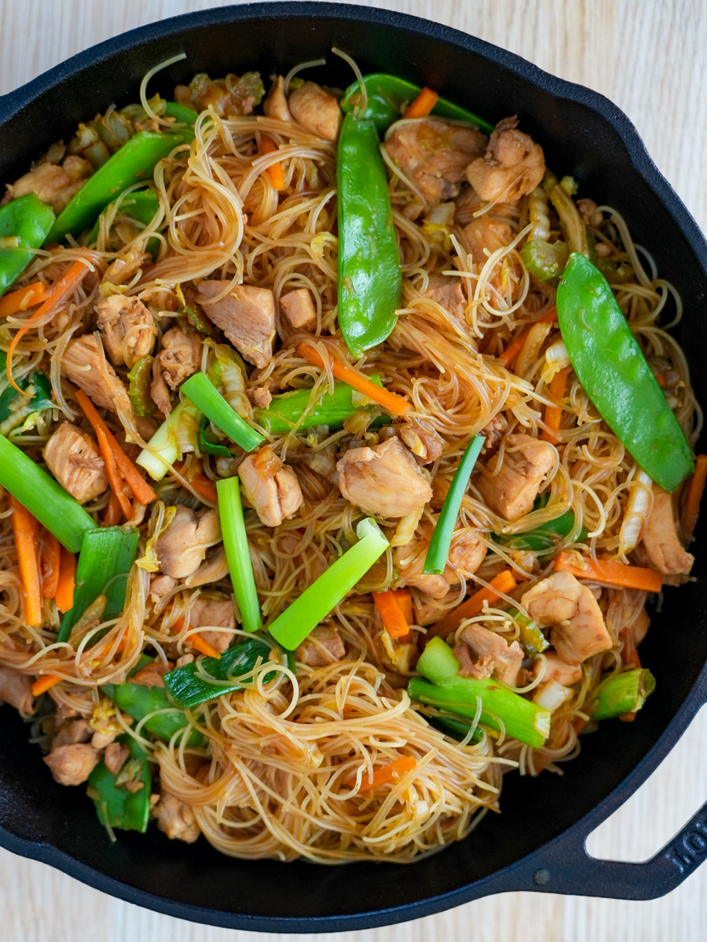 Filipino Stir-Fried Noodles with Chicken in cast iron pan