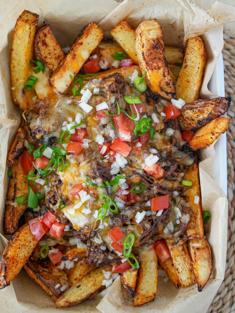 Delicious Beef Brisket Loaded Fries, showcasing fries topped with tender brisket, cheese, and savory toppings.