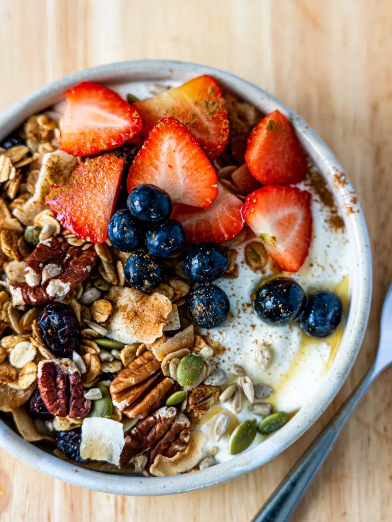 Overhead shot of homemade granola with mixed nuts and dried berries.