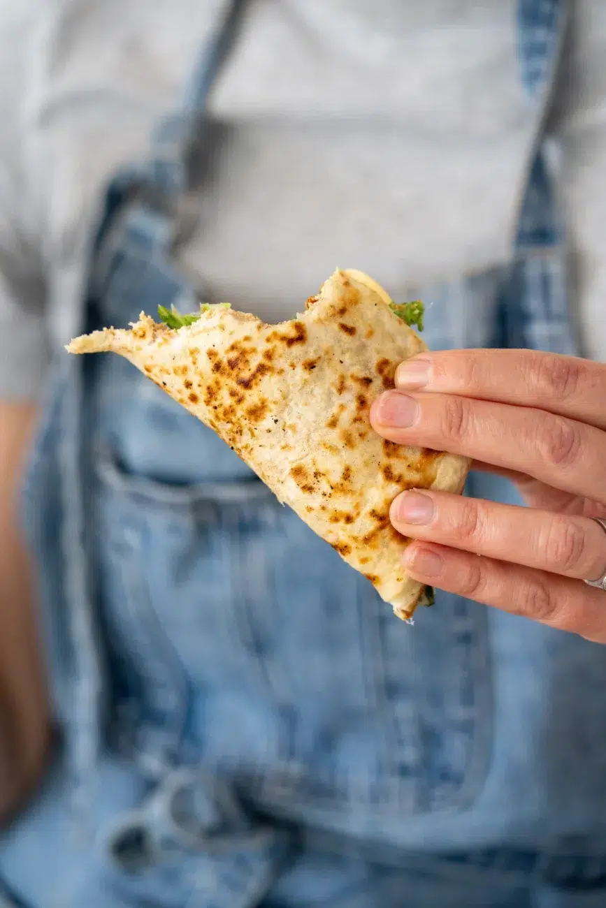 Nicole Holding a Chicken Caesar Smash Tacos