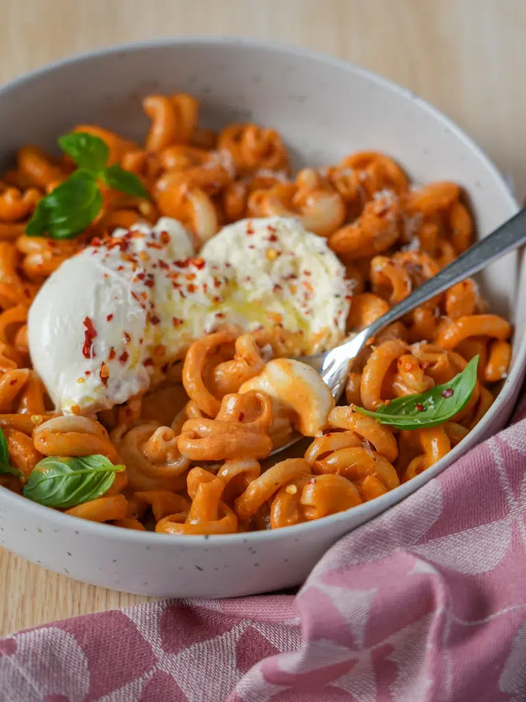 A bowl of Not Spicy, Not Vodka Pasta with a fork lifting a bite of pasta, highlighting the rich, creamy sauce.