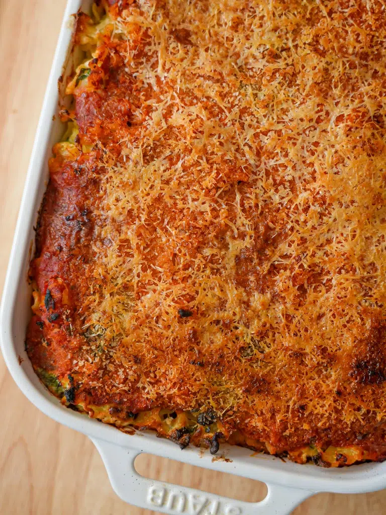 Delicious creamy spinach and cheese pasta bake, highlighting its golden crust.