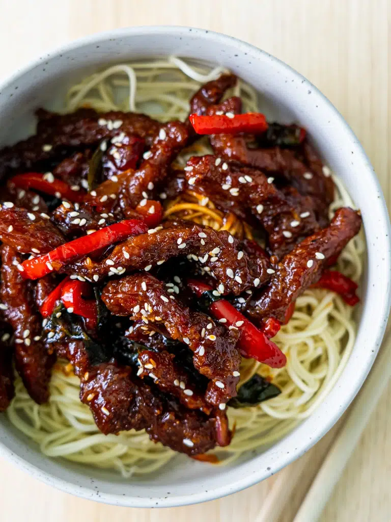 Close-up overhead shot of plated Sticky Rainbow Beef.