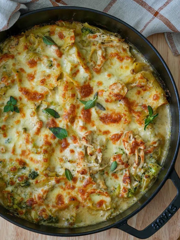 Top view of a pan filled with creamy Chicken and Broccoli Lasagne, topped with golden melted cheese.